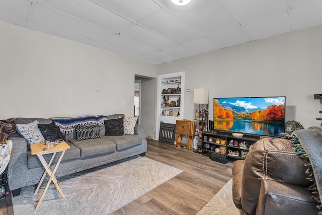 837 Backus St, Jackson, MI 49202 - living area with wood finished floors, a drop ceiling, and built in features