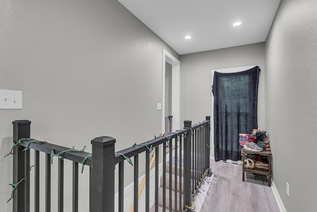 837 Backus St, Jackson, MI 49202 - hallway with wood finished floors, an upstairs landing, recessed lighting, and baseboards