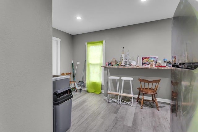 837 Backus St, Jackson, MI 49202 - bar featuring wood finished floors, recessed lighting, and baseboards