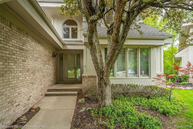 6560 Pleasant Lake Ct Unit 11, West Bloomfield, MI 48322 - doorway to property with roof with shingles and brick siding