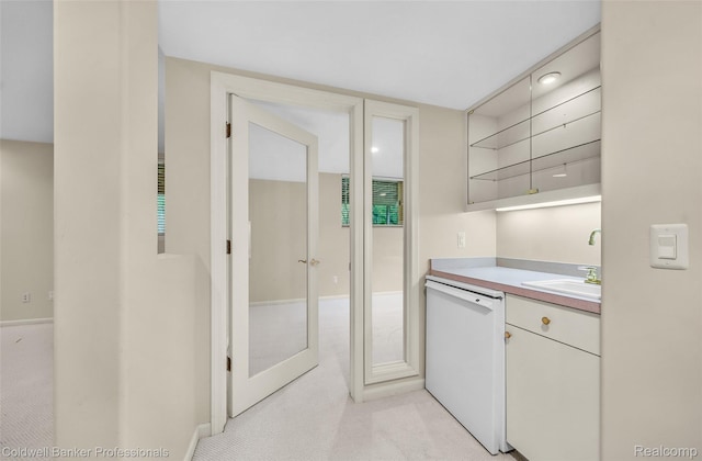 6560 Pleasant Lake Ct Unit 11, West Bloomfield, MI 48322 - kitchen featuring white dishwasher, open shelves, a sink, light countertops, and white cabinetry