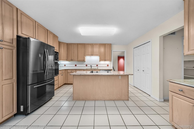 6560 Pleasant Lake Ct Unit 11, West Bloomfield, MI 48322 - kitchen with black appliances, a center island, tasteful backsplash, a sink, and light stone countertops