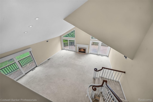 6560 Pleasant Lake Ct Unit 11, West Bloomfield, MI 48322 - unfurnished living room featuring lofted ceiling, a lit fireplace, and recessed lighting