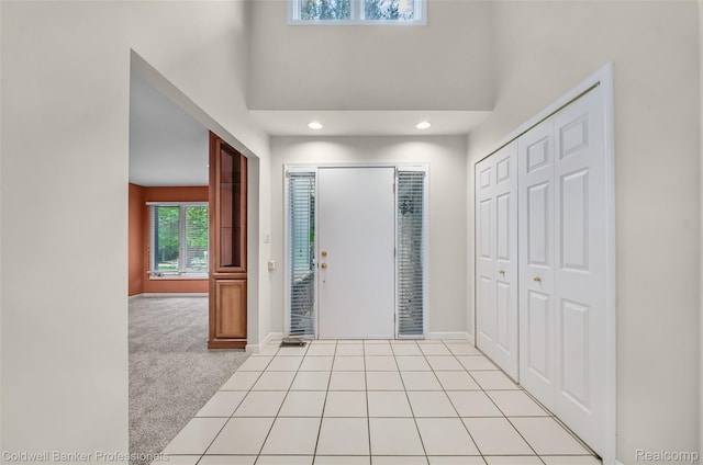 6560 Pleasant Lake Ct Unit 11, West Bloomfield, MI 48322 - entrance foyer with baseboards, light carpet, a towering ceiling, and recessed lighting