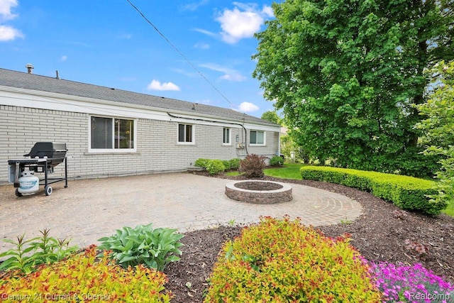 24018 Glen Ridge Ct, Novi, MI 48375 - rear view of house featuring a fire pit, a patio area, and a shingled roof