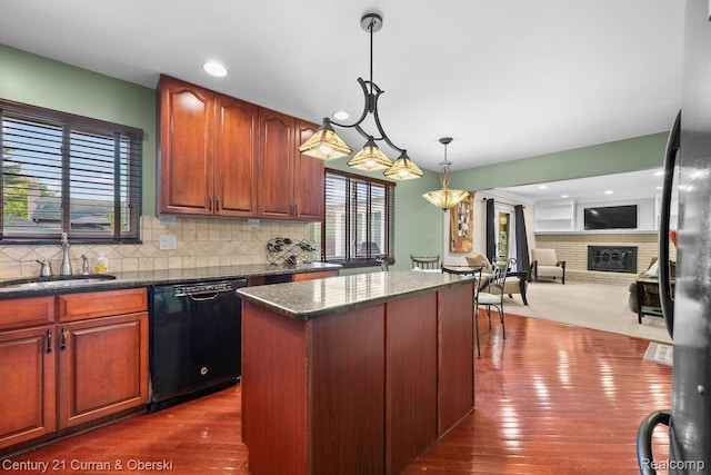 24018 Glen Ridge Ct, Novi, MI 48375 - kitchen with dishwasher, a sink, a center island, decorative light fixtures, and tasteful backsplash