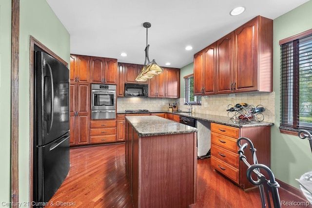 24018 Glen Ridge Ct, Novi, MI 48375 - kitchen featuring black appliances, a warming drawer, a sink, dark wood-style flooring, and a kitchen island