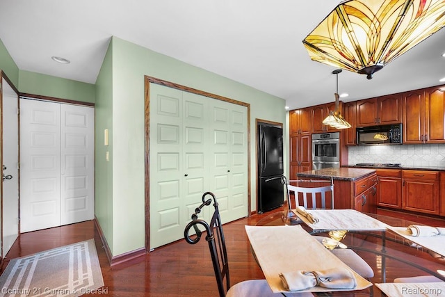 24018 Glen Ridge Ct, Novi, MI 48375 - kitchen with black appliances, tasteful backsplash, dark wood finished floors, a center island, and hanging light fixtures