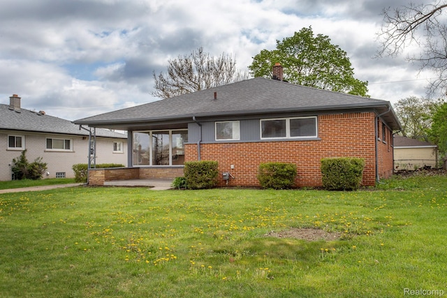 24548 Templar Ave, Southfield, MI 48075 - rear view of property with brick siding, a chimney, a lawn, and a shingled roof