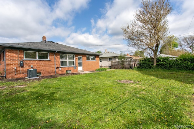 24548 Templar Ave, Southfield, MI 48075 - back of property with a chimney, brick siding, and central AC unit