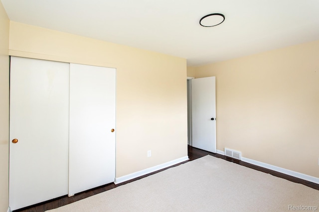 24548 Templar Ave, Southfield, MI 48075 - unfurnished bedroom with a closet, dark wood-style floors, and baseboards