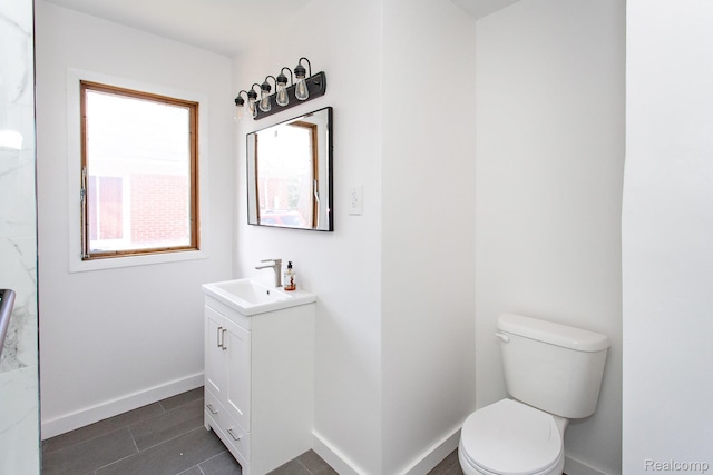 24548 Templar Ave, Southfield, MI 48075 - bathroom with vanity, toilet, baseboards, and tile patterned floors