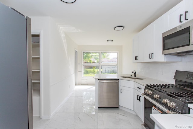 24548 Templar Ave, Southfield, MI 48075 - kitchen featuring appliances with stainless steel finishes, light marble finish floors, white cabinets, and light countertops