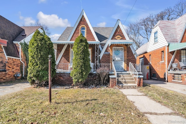 15075 Appoline St, Detroit, MI 48227 - english style home featuring brick siding, a front yard, and covered porch