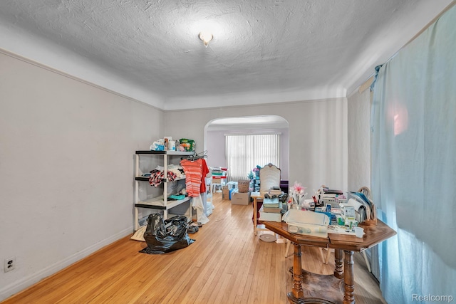 15075 Appoline St, Detroit, MI 48227 - interior space with arched walkways, hardwood / wood-style floors, a textured ceiling, and baseboards