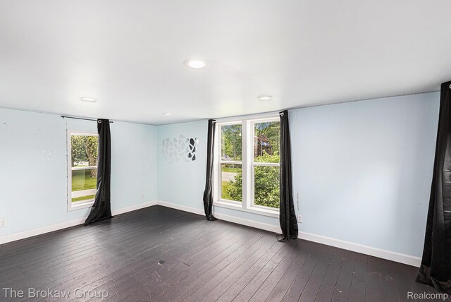 4470 Beach St, Akron, MI 48701 - empty room with recessed lighting, dark wood-style floors, healthy amount of natural light, and baseboards