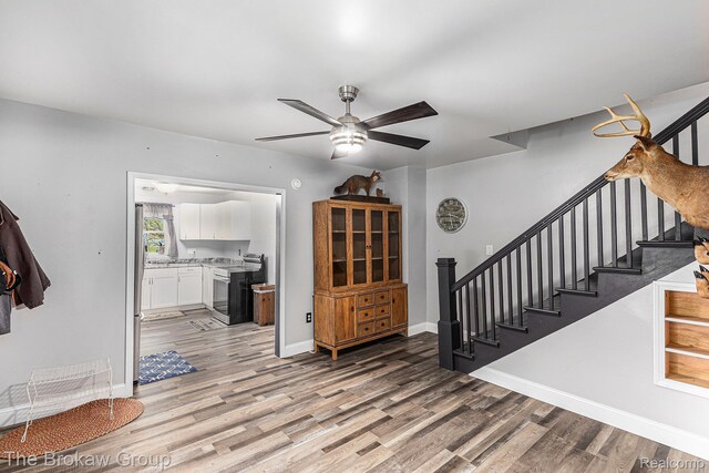 4470 Beach St, Akron, MI 48701 - foyer featuring light wood-style floors, stairway, a ceiling fan, and baseboards