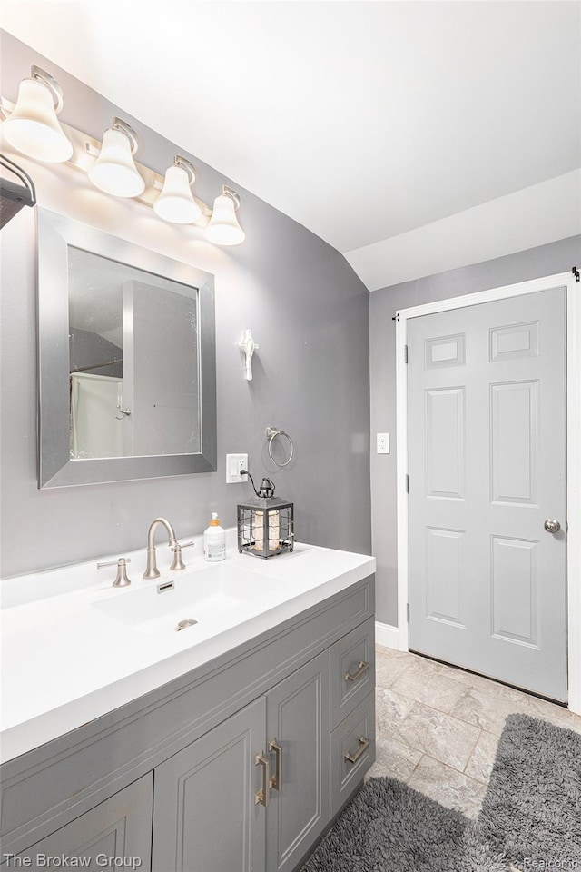 4470 Beach St, Akron, MI 48701 - bathroom featuring vanity, baseboards, and stone finish flooring