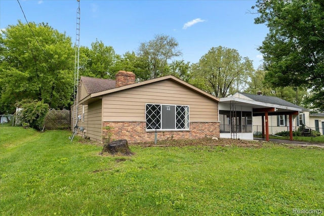 3301 S Kearsley Blvd, Flint, MI 48506 - view of front of home featuring brick siding, a chimney, and an attached carport