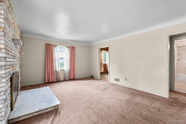 3301 S Kearsley Blvd, Flint, MI 48506 - unfurnished living room featuring a fireplace, carpet floors, and baseboards