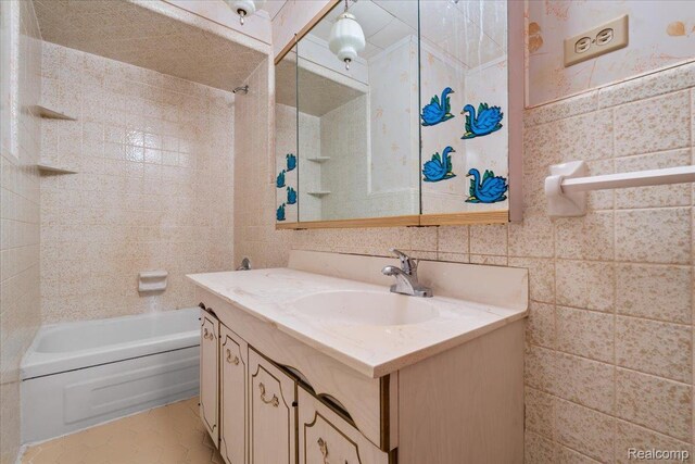 3301 S Kearsley Blvd, Flint, MI 48506 - full bath with vanity, tile walls, and bathing tub / shower combination