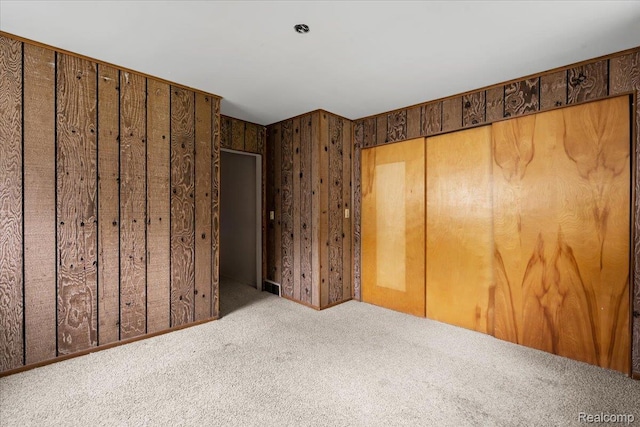 3301 S Kearsley Blvd, Flint, MI 48506 - unfurnished bedroom with carpet flooring and wooden walls