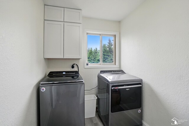 4853 Southpointe Pkwy, Monroe, MI 48161 - laundry room featuring cabinet space, separate washer and dryer, and wood finished floors