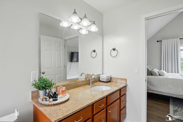 4853 Southpointe Pkwy, Monroe, MI 48161 - bathroom with vanity, connected bathroom, wood finished floors, and lofted ceiling