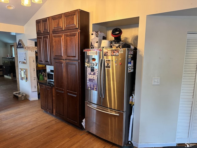 4211 Shelton Dr, Lambertville, MI 48144 - kitchen with freestanding refrigerator, light wood finished floors, vaulted ceiling, and dark brown cabinets