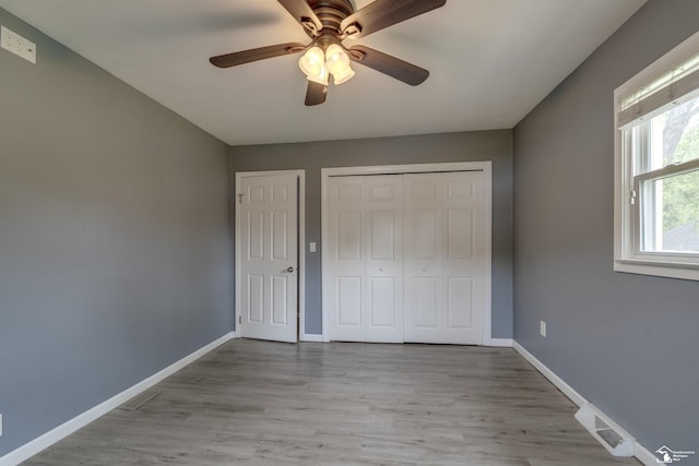 6432 Whiteford Center Rd, Lambertville, MI 48144 - unfurnished bedroom with wood finished floors, baseboards, ceiling fan, and a closet
