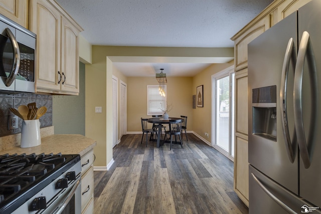 6432 Whiteford Center Rd, Lambertville, MI 48144 - kitchen with stainless steel appliances, light brown cabinets, light countertops, dark wood-style floors, and baseboards