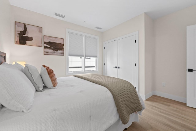 708 Randolph St, Traverse City, MI 49684 - bedroom with light wood-style flooring, baseboards, and a closet