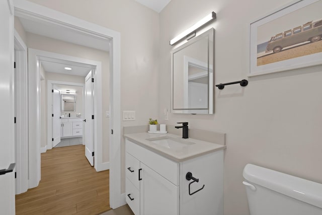 708 Randolph St, Traverse City, MI 49684 - bathroom with vanity, wood finished floors, toilet, and baseboards