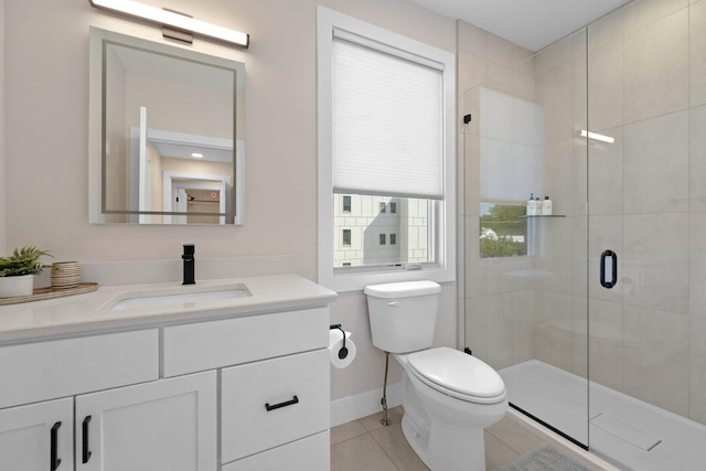 708 Randolph St, Traverse City, MI 49684 - bathroom featuring vanity, toilet, tile patterned flooring, a stall shower, and baseboards