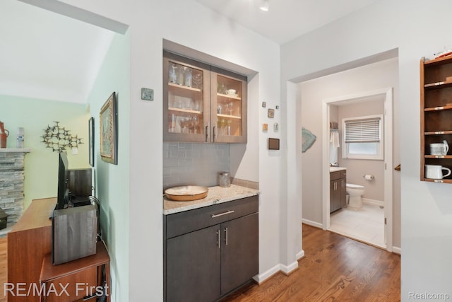 2681 Buckingham Ave, Birmingham, MI 48009 - bar featuring decorative backsplash, wood finished floors, and baseboards