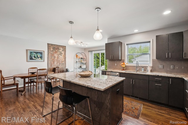 2681 Buckingham Ave, Birmingham, MI 48009 - kitchen with a sink, a kitchen bar, backsplash, dishwasher, and recessed lighting