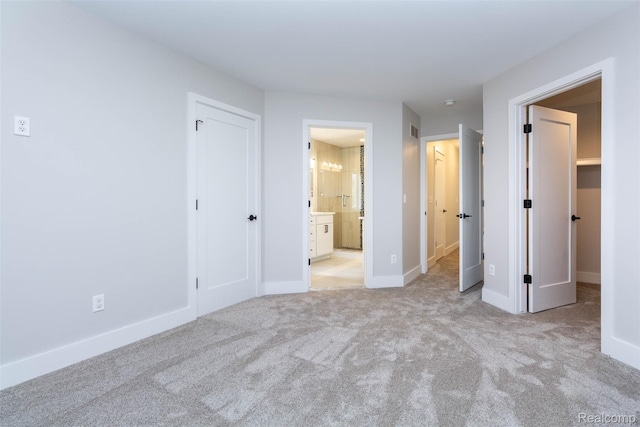 123 Mason Ct Unit 2, Royal Oak, MI 48067 - unfurnished bedroom featuring light carpet, baseboards, and ensuite bathroom