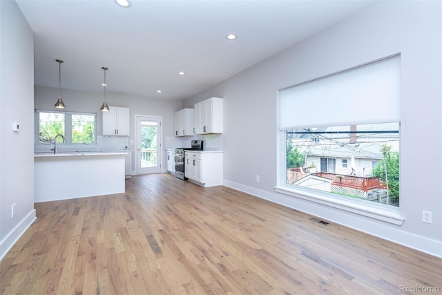 123 Mason Ct Unit 2, Royal Oak, MI 48067 - unfurnished living room with light wood-style floors, baseboards, recessed lighting, and a sink