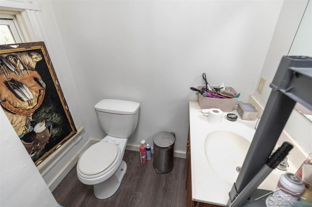 1221 Marsac St, Bay City, MI 48708 - bathroom featuring toilet, wood finished floors, and a sink