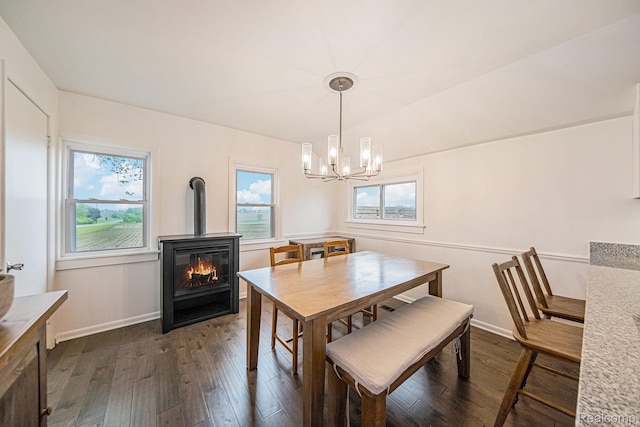 4340 Austin Rd, Saline, MI 48176 - dining room with dark wood-type flooring, a chandelier, baseboards, and a wood stove