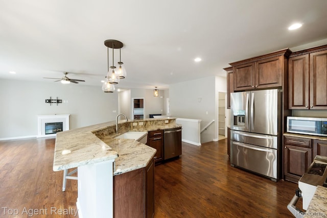 109 Willow Lake Dr, Oxford, MI 48371 - kitchen featuring stainless steel appliances, a sink, open floor plan, a ceiling fan, and dark wood finished floors
