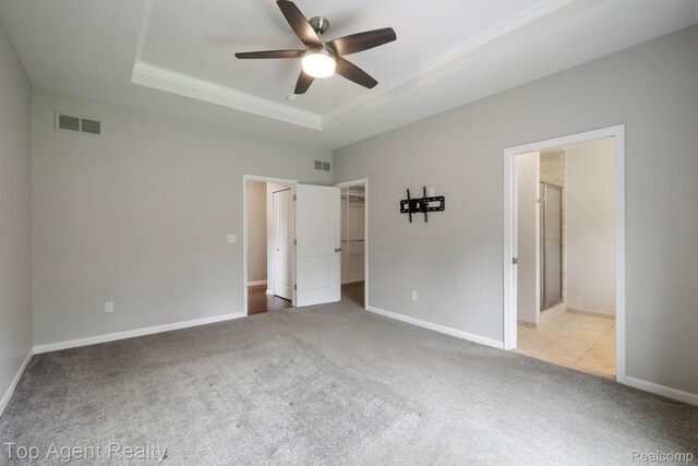 109 Willow Lake Dr, Oxford, MI 48371 - unfurnished bedroom with a raised ceiling, carpet, a spacious closet, ornamental molding, and baseboards