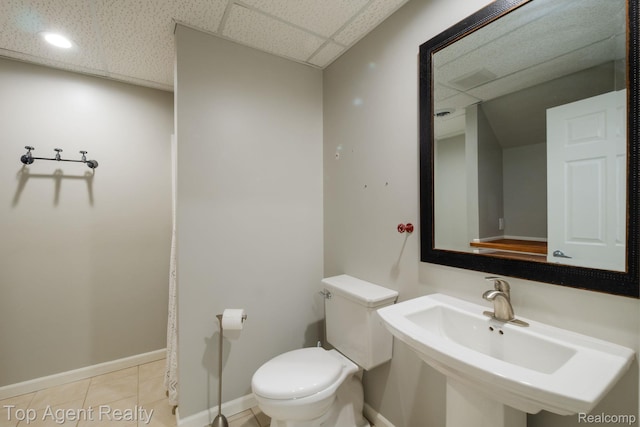 109 Willow Lake Dr, Oxford, MI 48371 - bathroom featuring a drop ceiling, toilet, baseboards, tile patterned flooring, and a sink