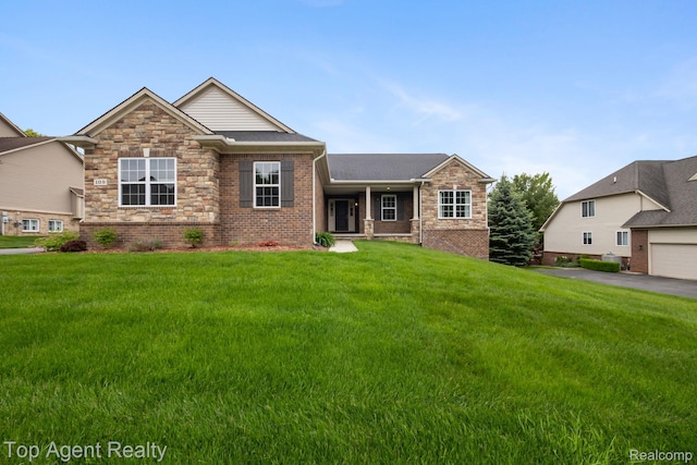 109 Willow Lake Dr, Oxford, MI 48371 - view of front of home featuring brick siding, a front lawn, and roof with shingles