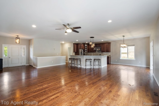 109 Willow Lake Dr, Oxford, MI 48371 - unfurnished living room featuring a chandelier, ceiling fan, baseboards, recessed lighting, and dark wood-style floors