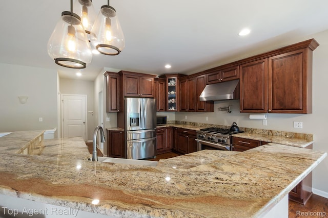 109 Willow Lake Dr, Oxford, MI 48371 - kitchen with under cabinet range hood, appliances with stainless steel finishes, light stone counters, glass insert cabinets, and recessed lighting
