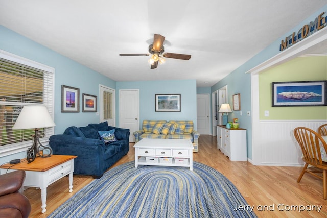 2058 N White Birch Dr, Mears, MI 49436 - living area featuring light wood-style flooring, ceiling fan, and wainscoting
