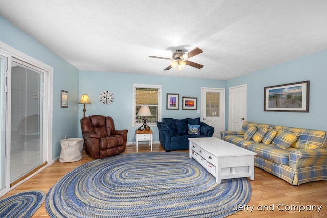 2058 N White Birch Dr, Mears, MI 49436 - living area with light wood finished floors, ceiling fan, and baseboards