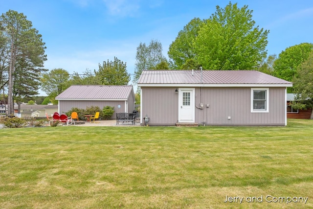 2058 N White Birch Dr, Mears, MI 49436 - rear view of house with a yard, metal roof, and a patio area