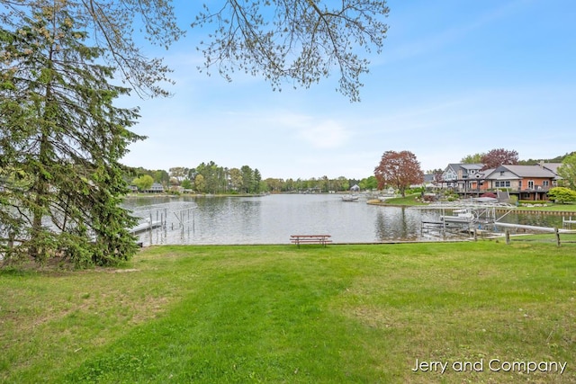 2058 N White Birch Dr, Mears, MI 49436 - dock with a lawn and a water view